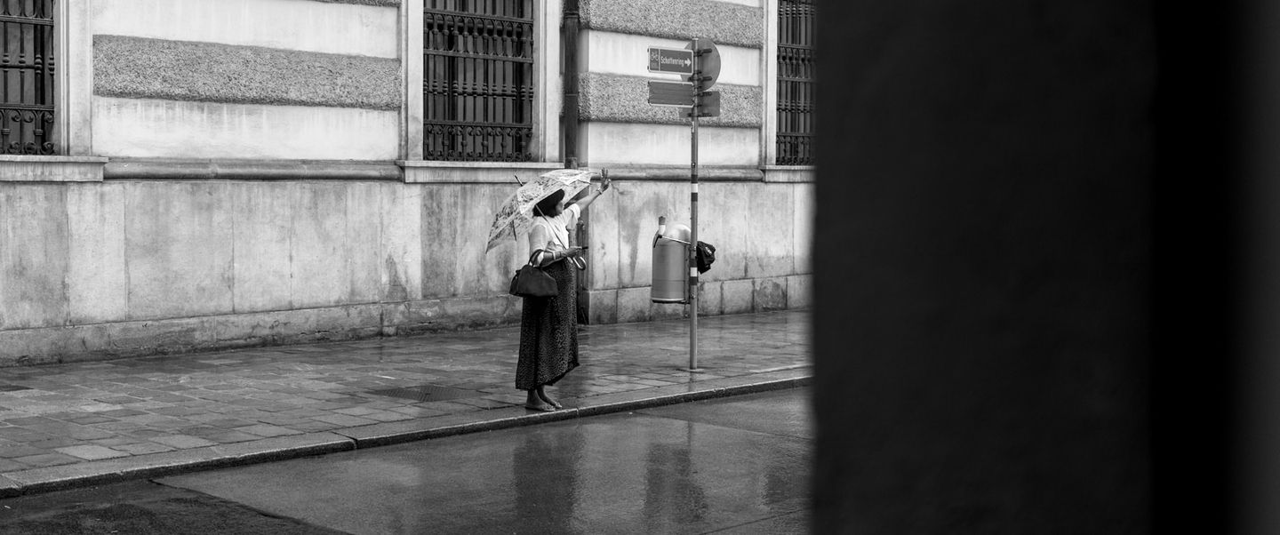 A cinematic photo of a woman hailing a taxi cab