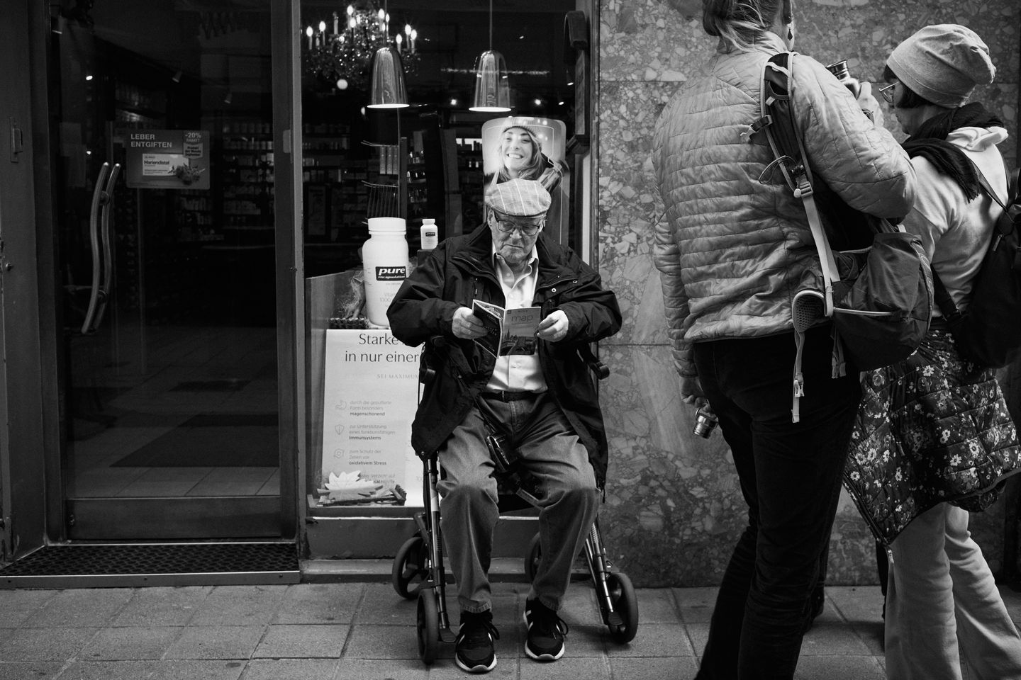 A man sits quietly reading a map