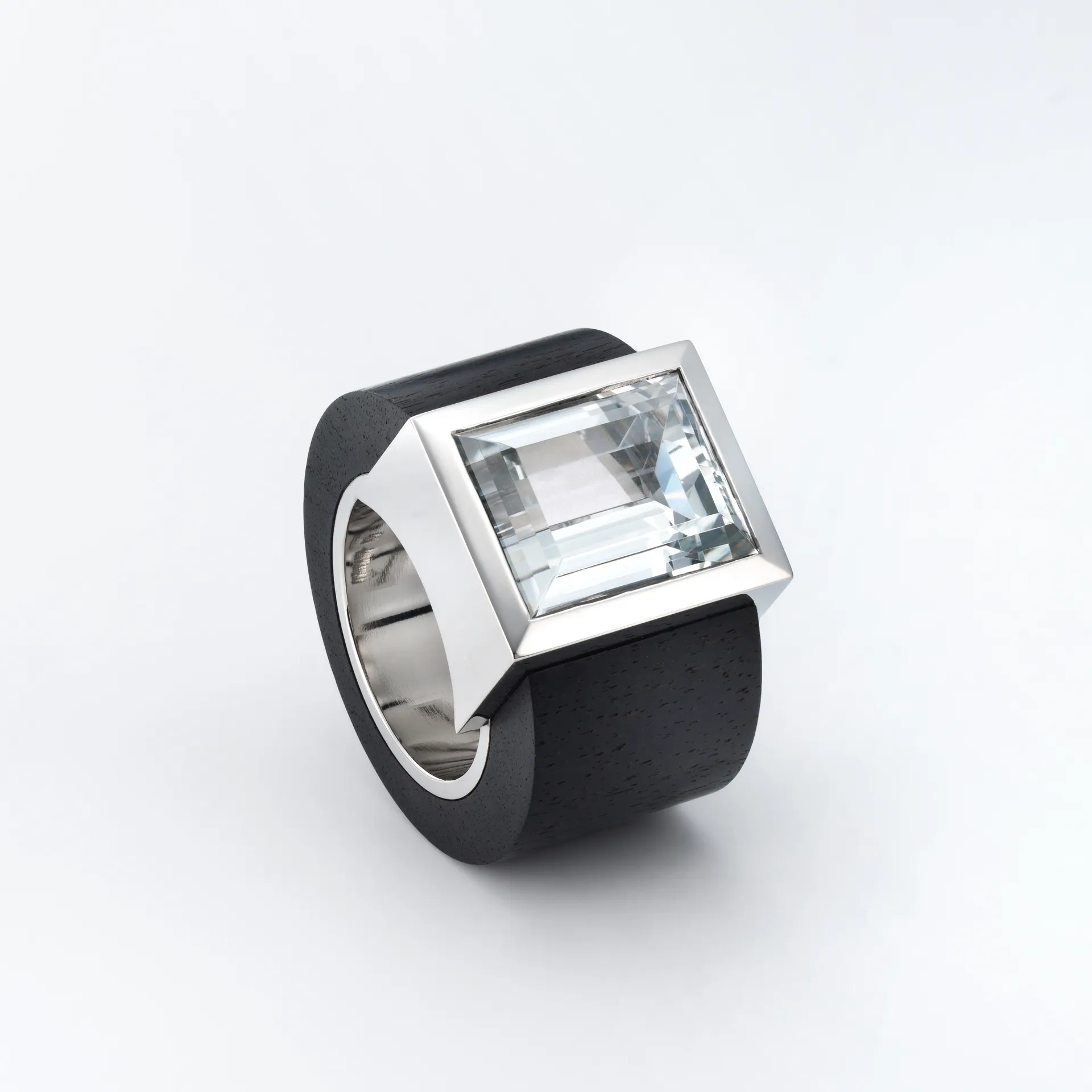 Kantiger Ring aus Platin und schwarzem Grenadillholt mit eckiger Fassung und weißem Topas