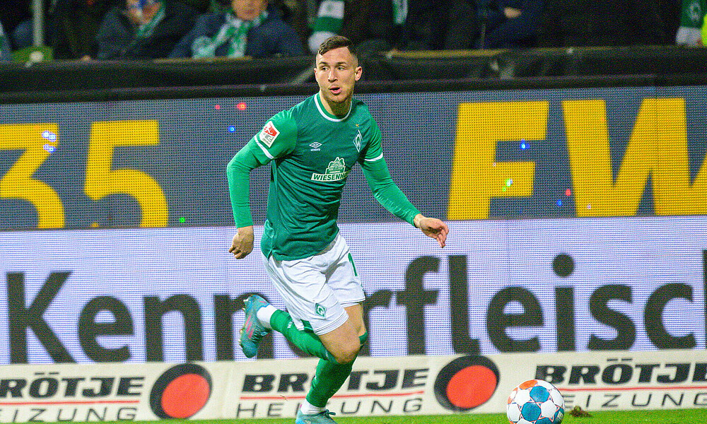 Schönfelder mit Ball am Fuß im Werder-Trikot. 