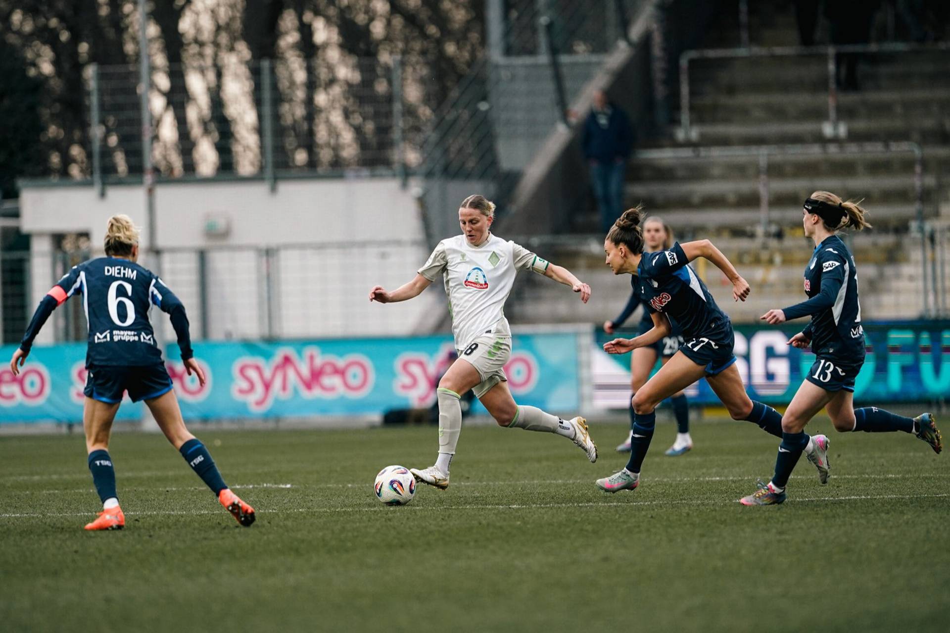 Lina Hausicke mit dem Ball am Fuß, Gegenspielerinnen verfolgen sie.