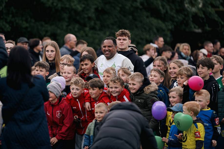 Ailton gemeinsam mit den Kinder beim Foto machen.