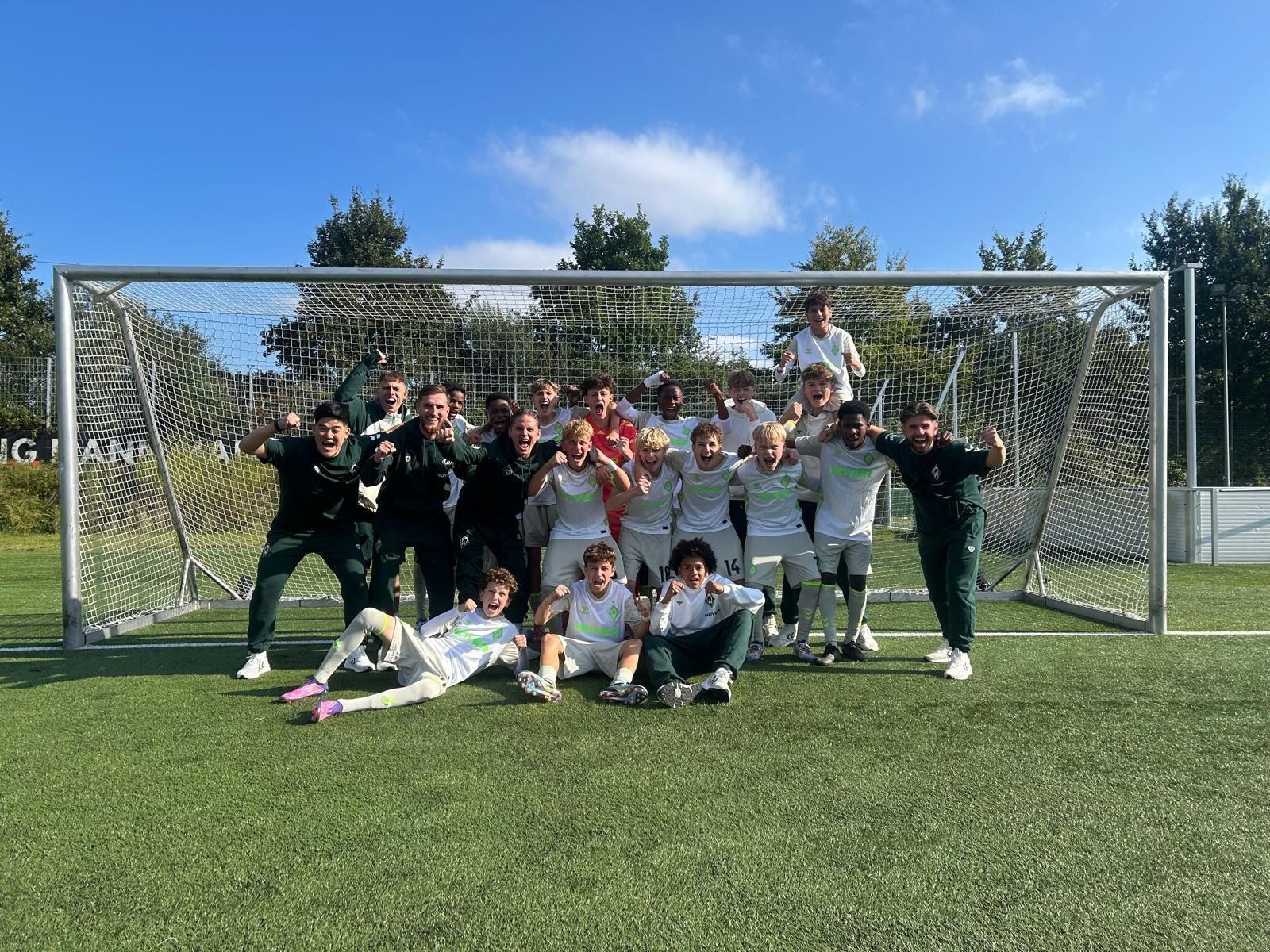 Werders U15 feiert auf einem Mannschaftsbild. Alle jubeln indem sie die Arme hochreißen.