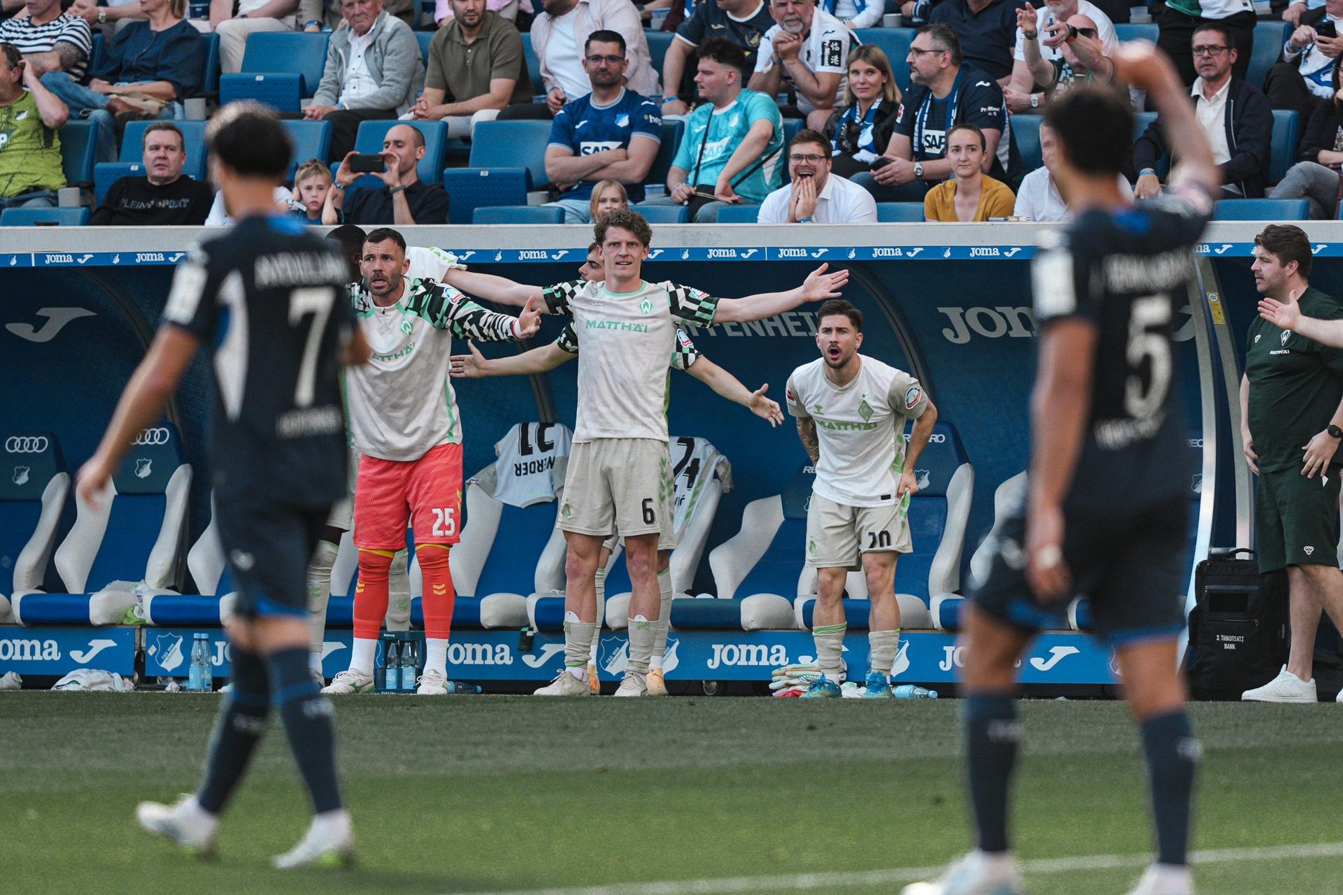 Jens Stage, Romano Schmid and Markus Kolke wave their arms in protest.