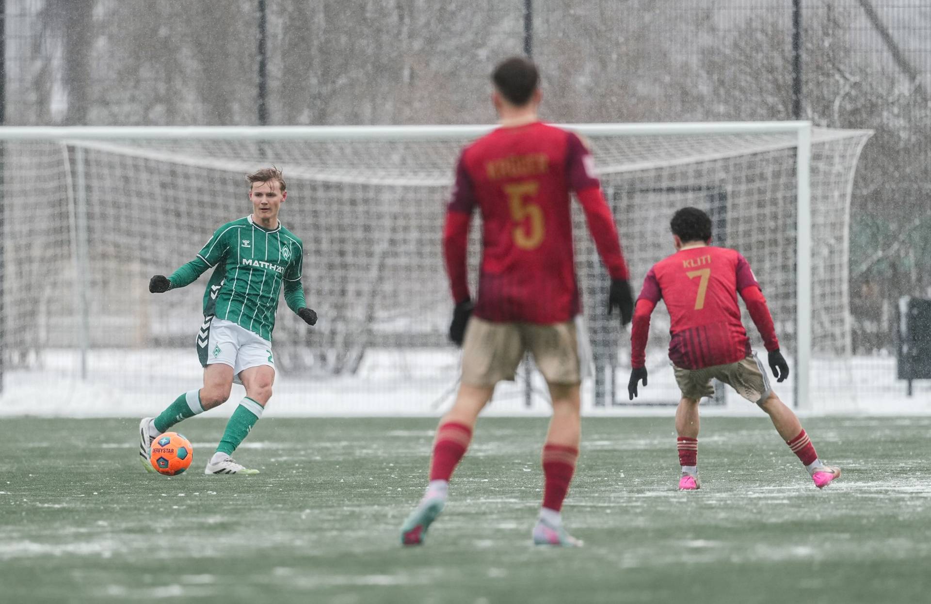 Paul Bellmann spielt einen Pass und wird von Gegenspielern angelaufen.
