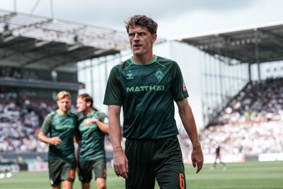 Jens Stage geht über den Platz am Millerntor in einem Werder-Aufwärmshirt.