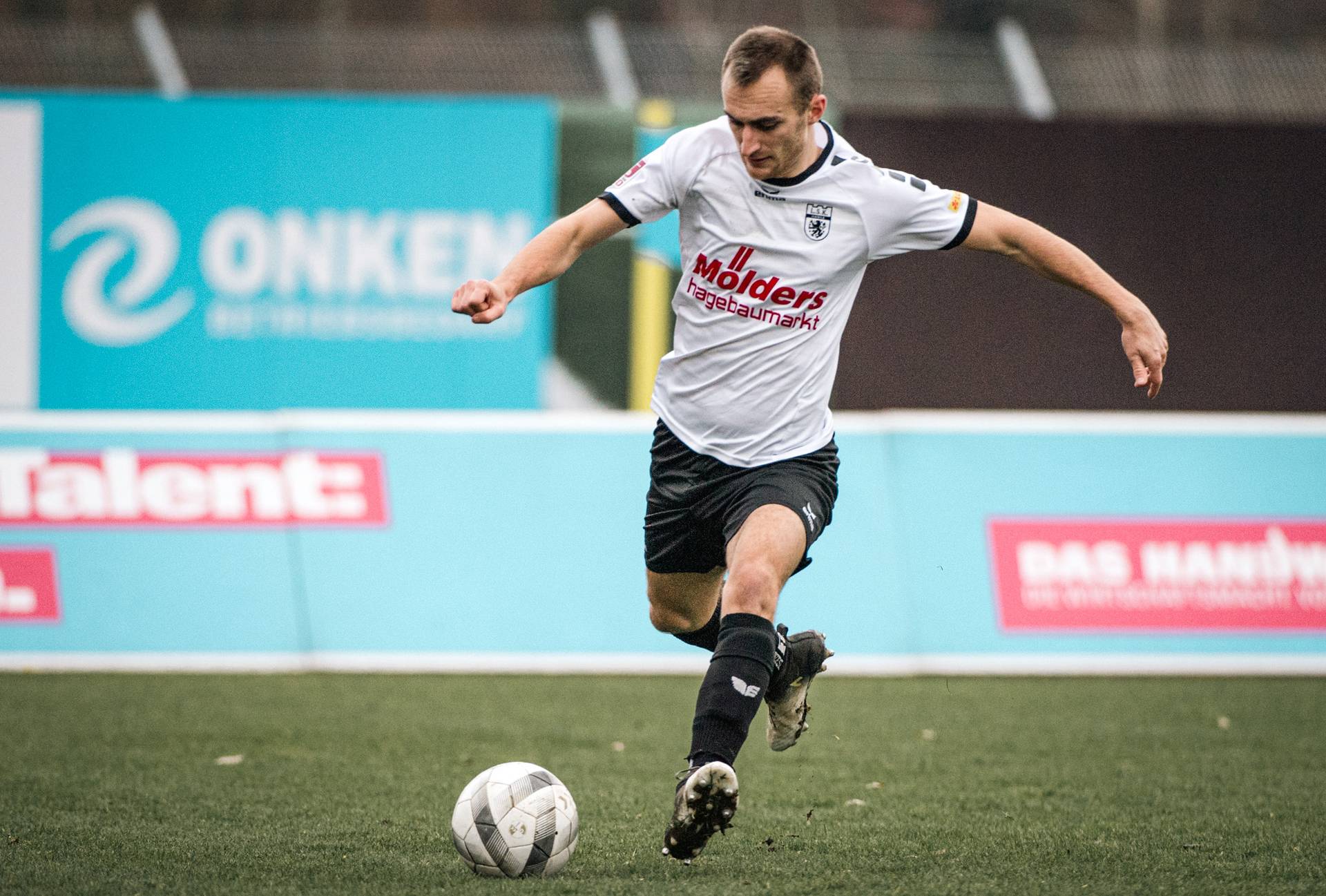 Marian Kunze im LSK-Trikot mit Ball am Fuß.