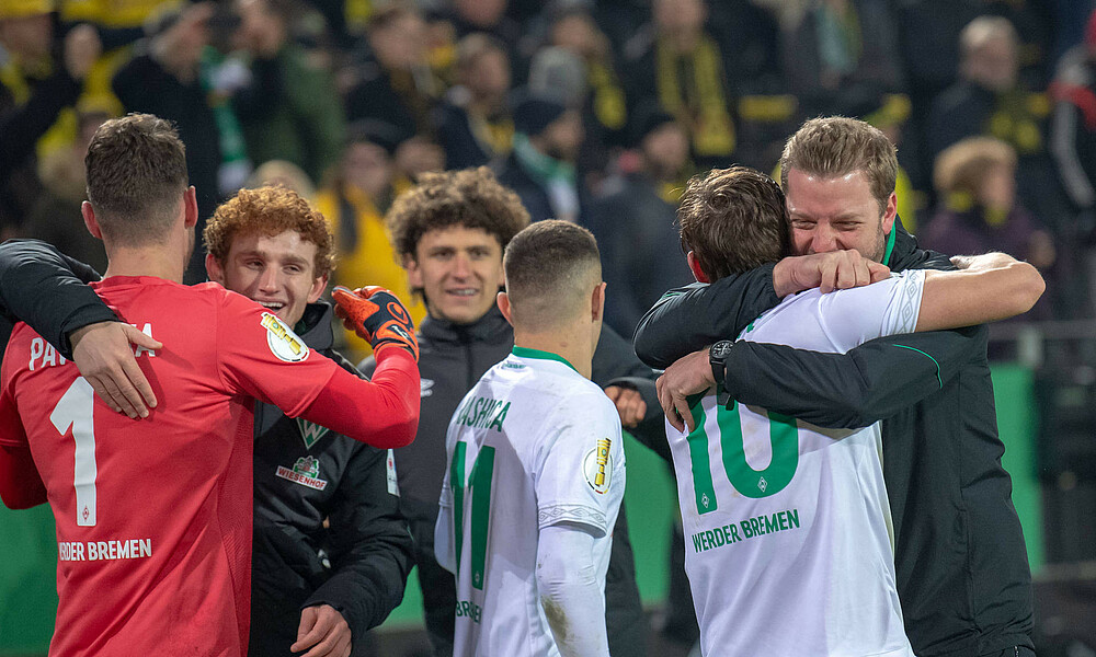 Werder feiert nach dem Sieg im DFB-Pokal gegen Borussia Dortmund 2019. Kohfeldt umarmt Kruse.