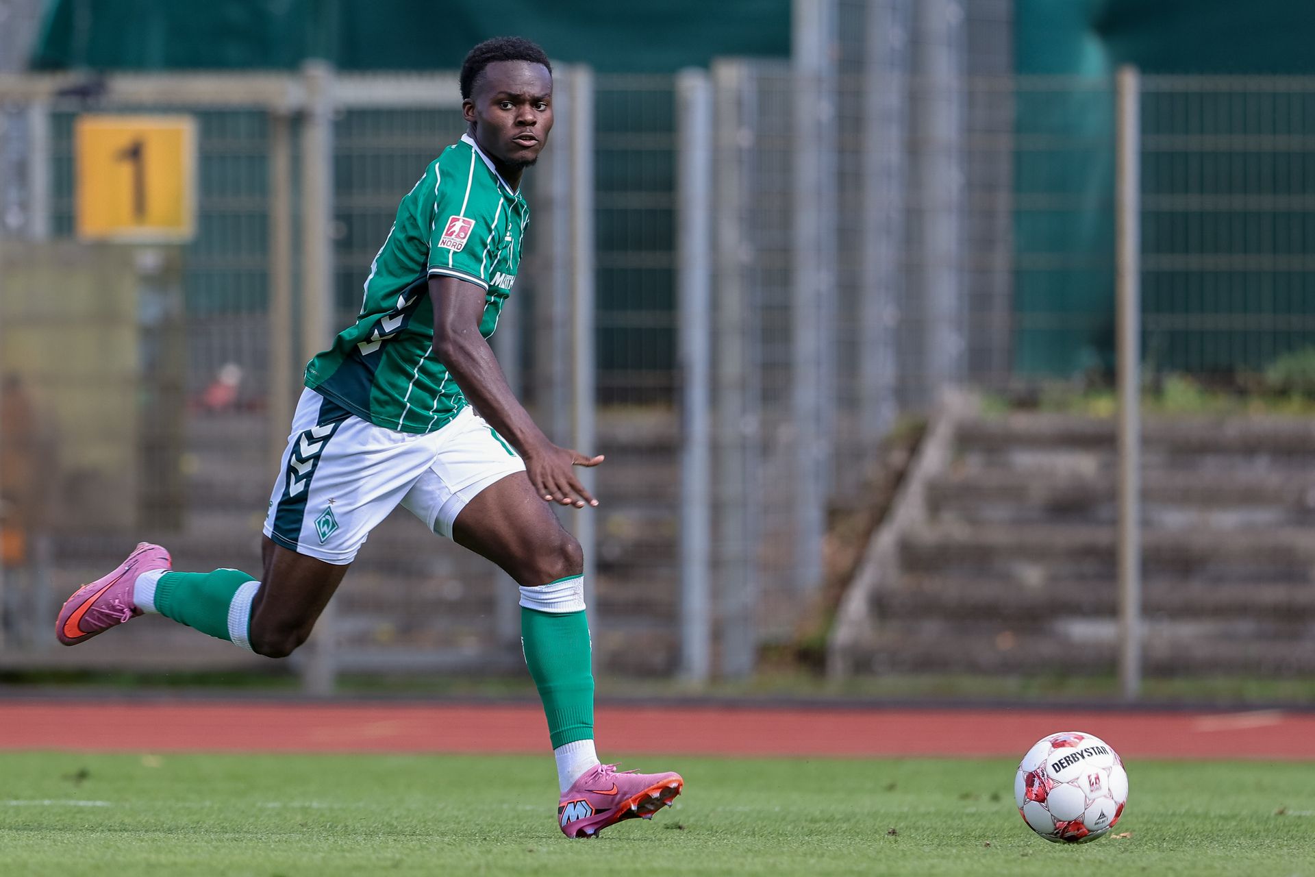Ein Werder-Spieler sprintet dem Ball hinterher.