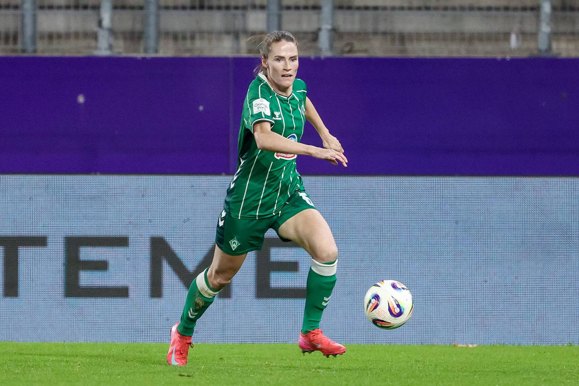 Reena Wichmann im Heimtrikot während eines Spiels im Lauf mit Ball.