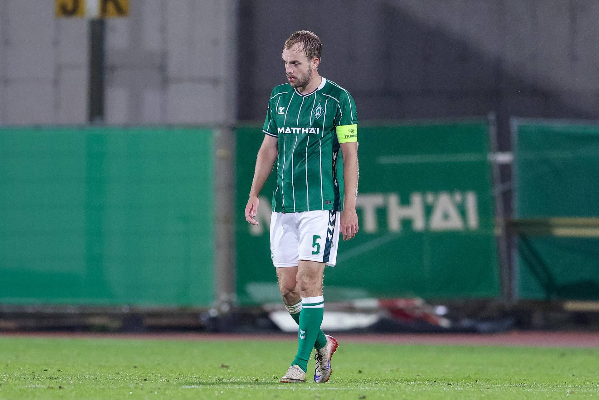Ein Spieler im Werder-Trikot geht über den Platz