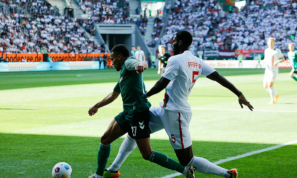 Felix Agu ist im Strafraum vor Pfeiffer am Ball. 
