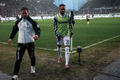 Felix Agu geht vom Platz. Neben ihm ein Staff-Mitglied des SV Werder.