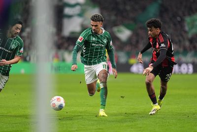 Justin Njinmah chases the ball, as does Frankfurt's Nathaniel Brown.
