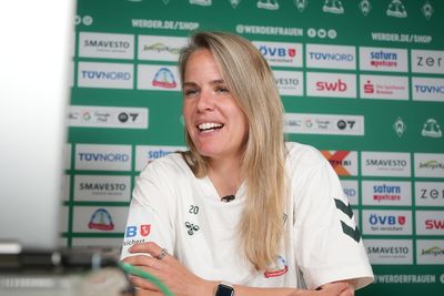 Lena Petermann schaut auf einen Laptop und spricht.