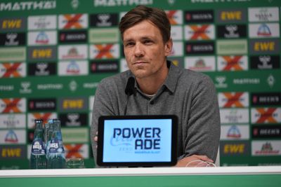 GeschäftsführerFußball Clemens Fritz auf dem Podium bei der Pressekonferenz im grauen Polosweatshirt
