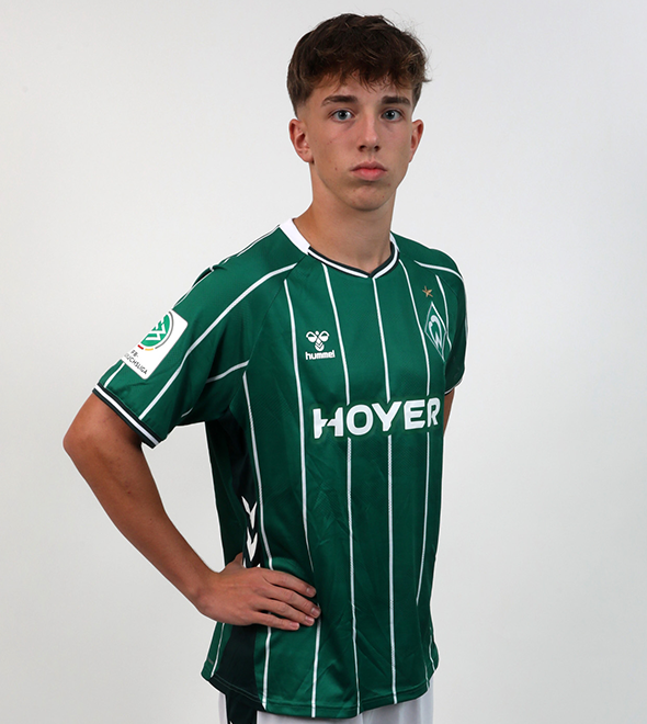 Portrait von Hans Alexander Tretau. Er stemmt die Hände in die Hüften.