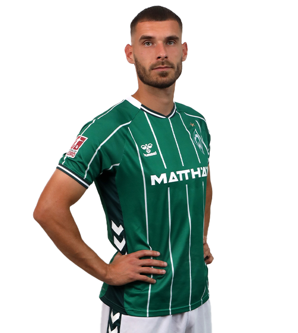 Portrait von Christian Stark. Er stemmt die Hände in die Hüften.