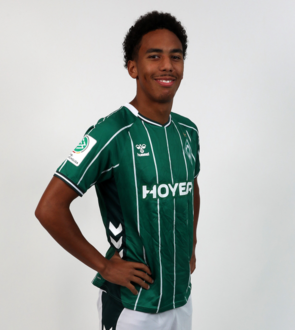 Portrait von Paul Erevbenagie. Er stemmt die Hände in die Hüften.