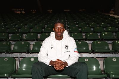 Karim Coulibaly sitzt auf einem Platz in der Ostkurve.