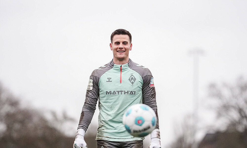 Michael Zetterer lächelt in die Kamera im Teamtraining