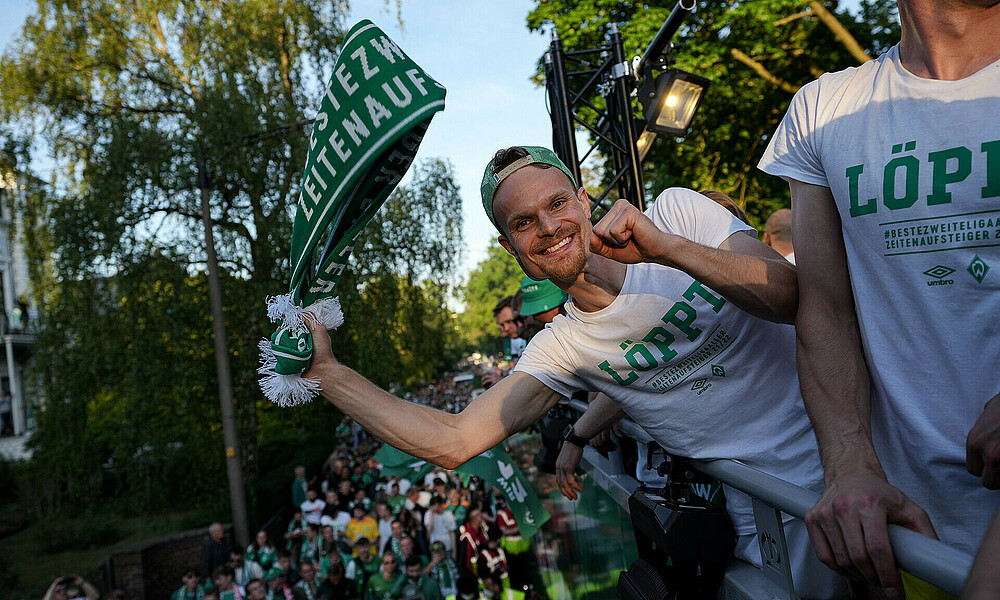null Christian Groß lehnt sich vom Truck, unten laufen die Fans.
