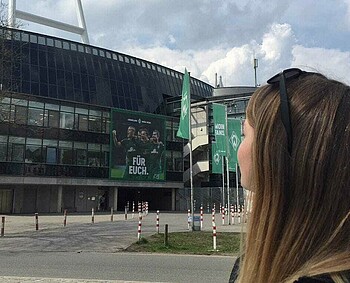 Fanin Greta Rinast vor dem wohninvest WESERSTADION.