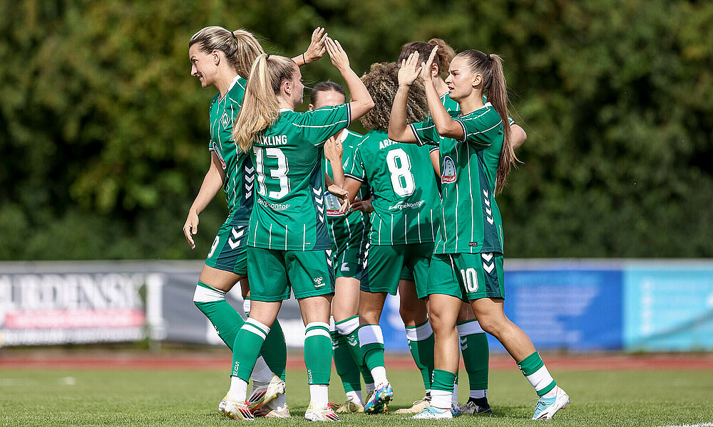 null Die Werder-Frauen klatschen sich nach einem Torerfolg ab.