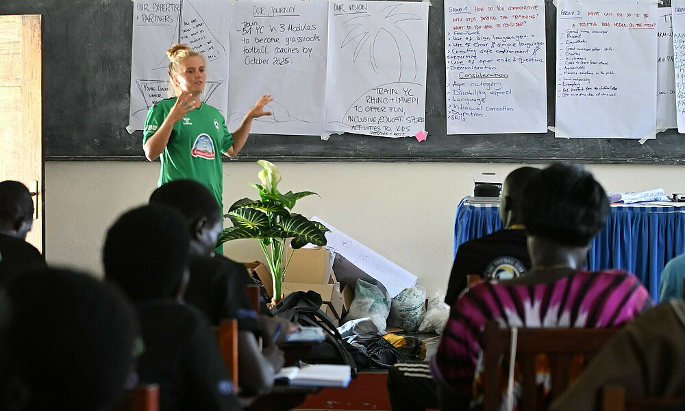 Bundesliga-Spielerin Ricarda Walkling vom SV Werder steht vor einer Klasse von Young Coaches in Uganda