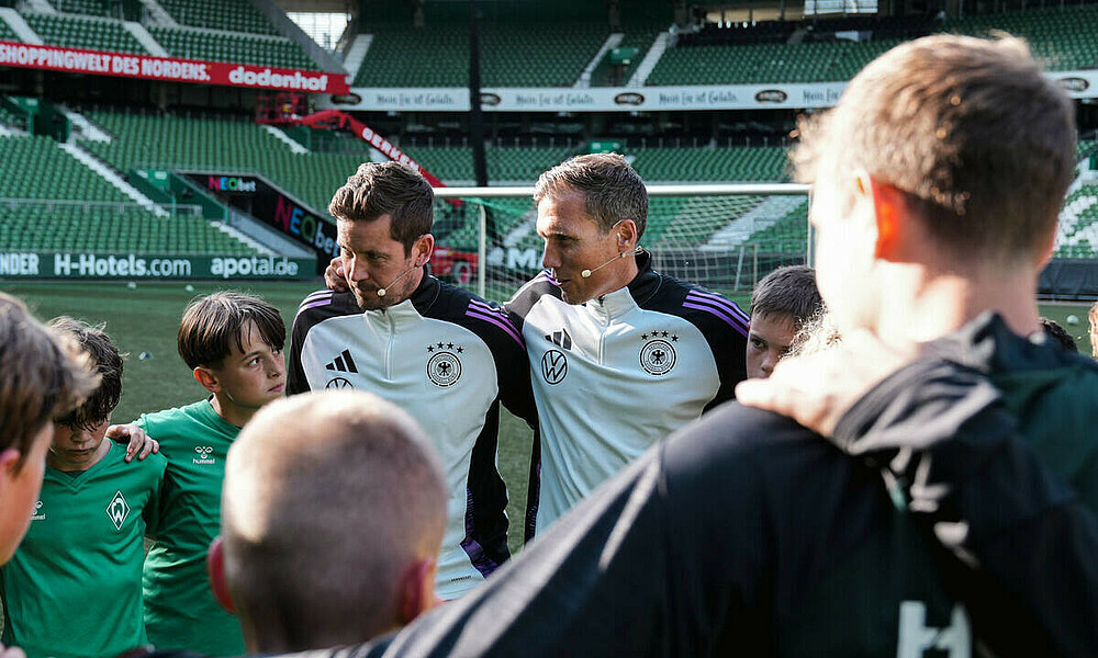 null Hannes Wolf steht mit einer Gruppe Kindern im Kreis