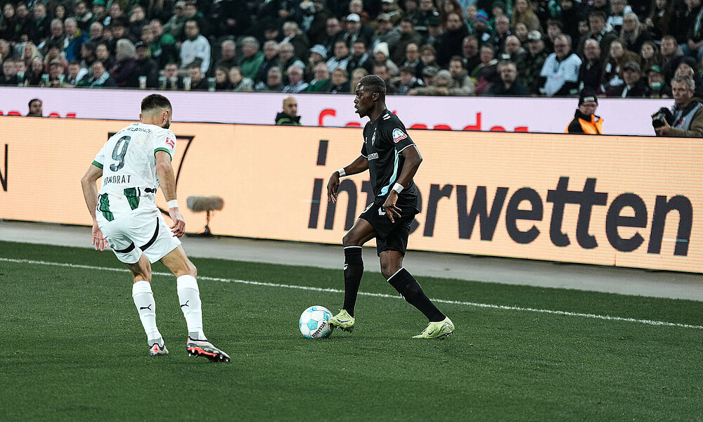 Derrick Köhn am Ball vor Honorat. 