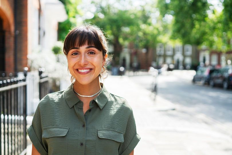 Smiling woman in a bright neighborhood