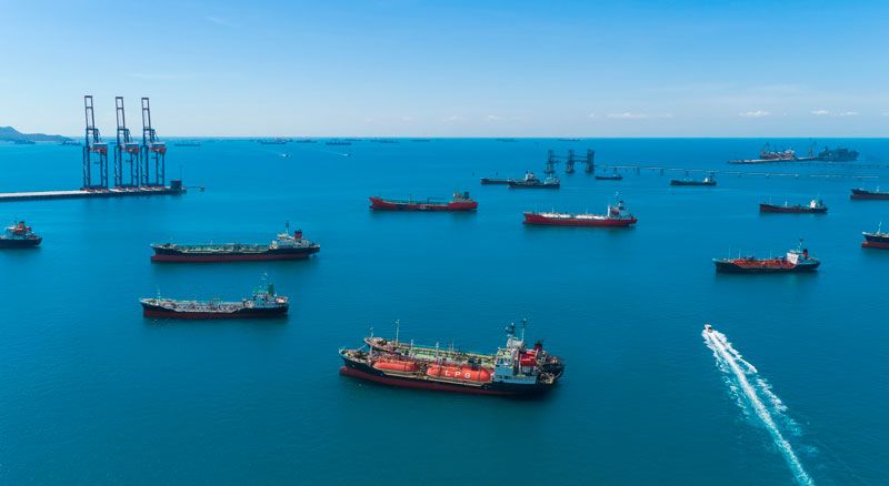 Emerging Markets Outlook with ships moored in the Strait of Hormuz