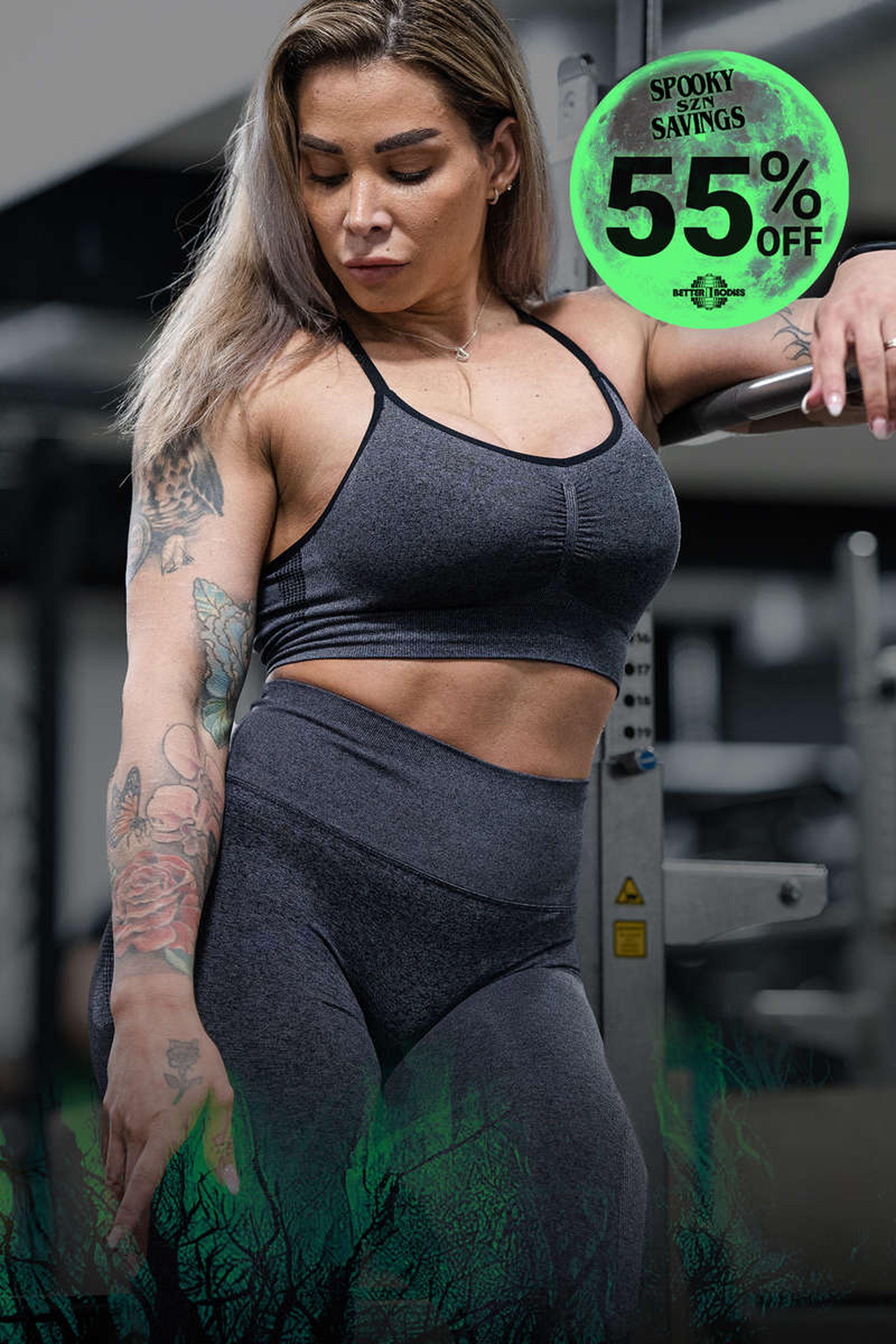 Woman in a gym wearing a dark workout outfit, surrounded by a spooky-themed 55% off discount graphic.