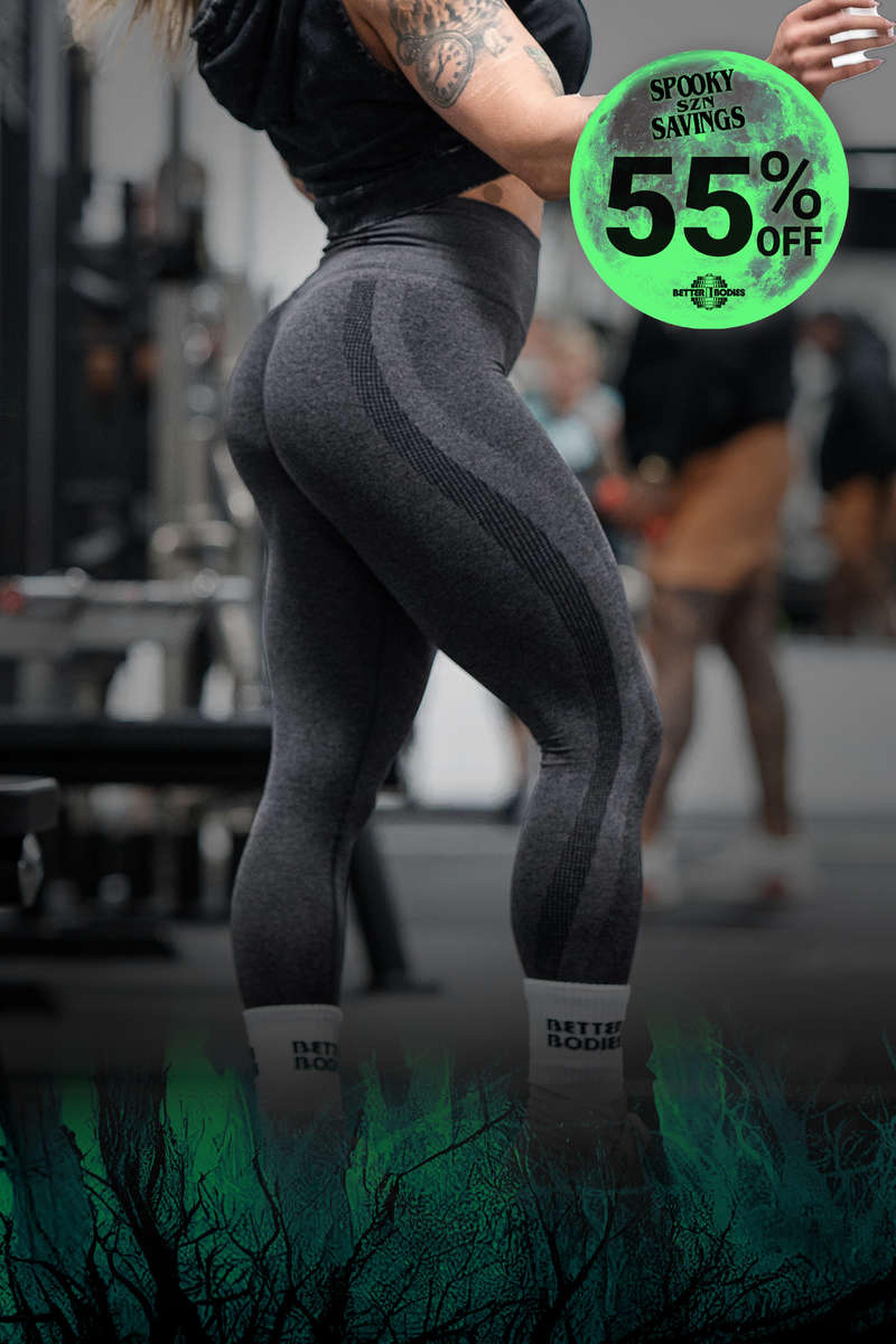 Person in gym wearing dark leggings and socks, with a "Spooky Savings 55% Off" graphic overlay featuring a green, eerie design.