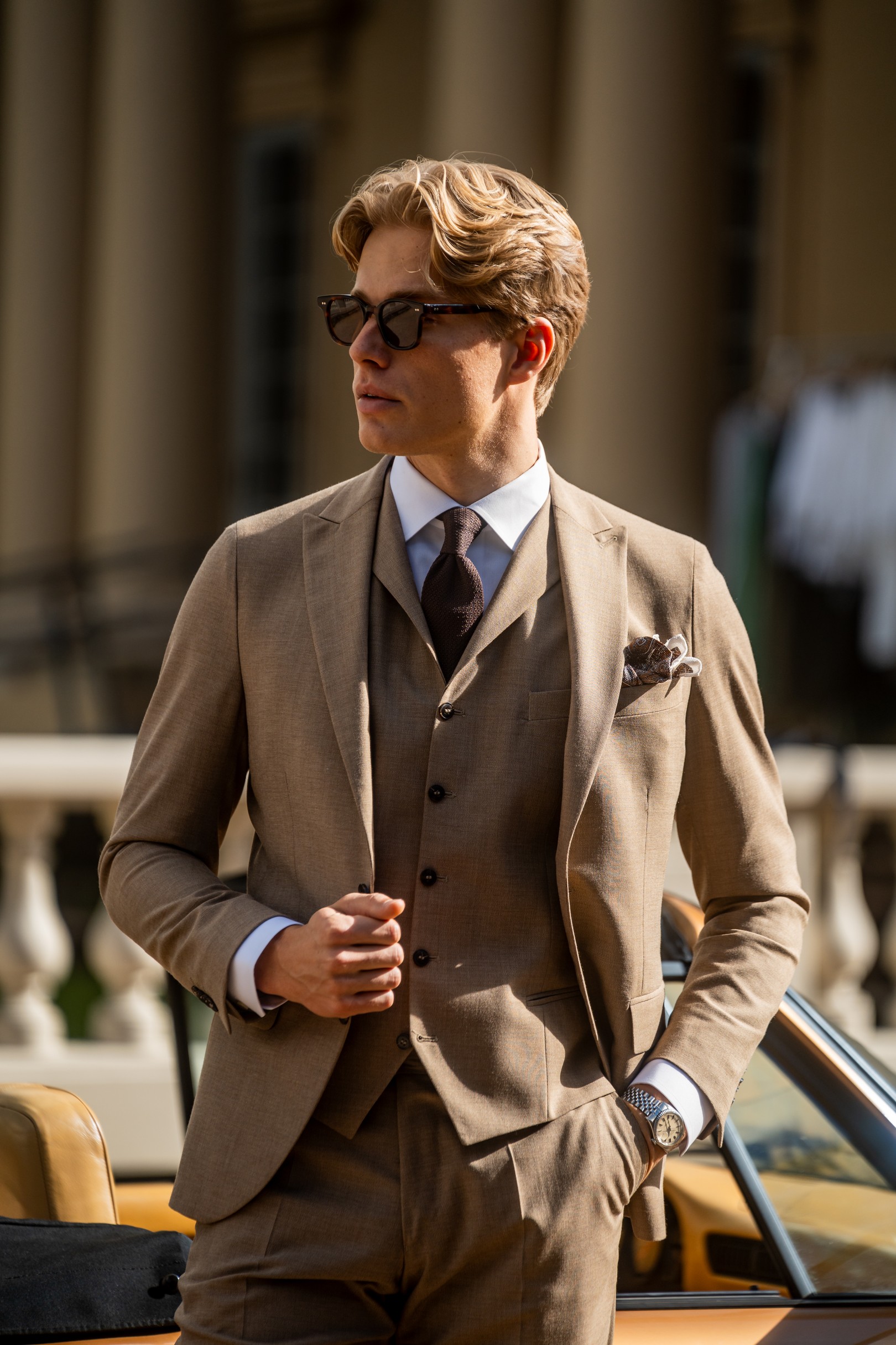 Man wearing beige suit