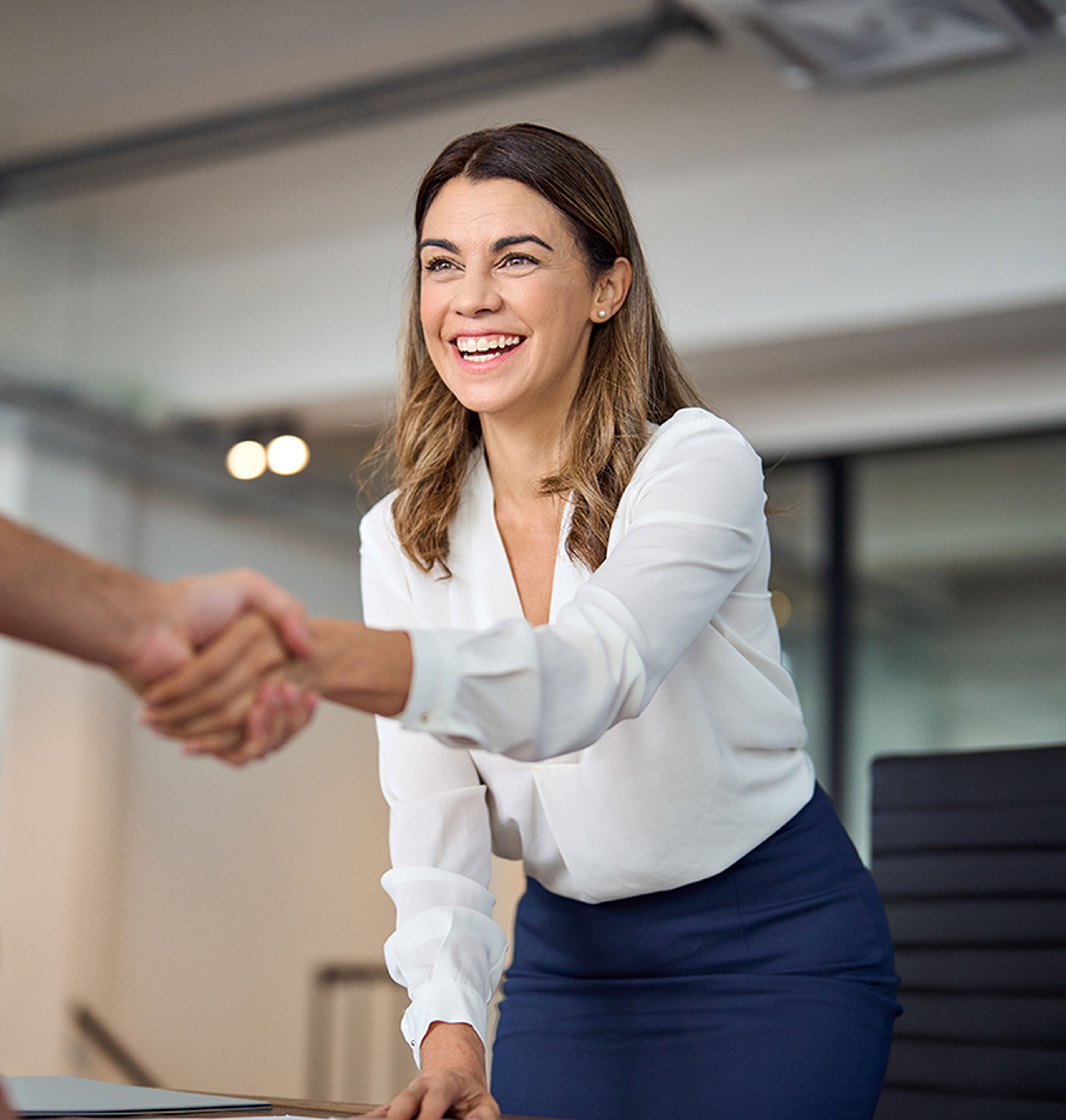 Two people in a business meeting having a joyful discussion