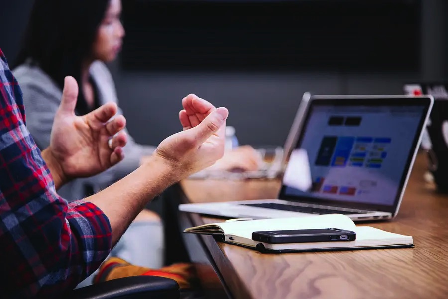 Man Communicating at Conference Table