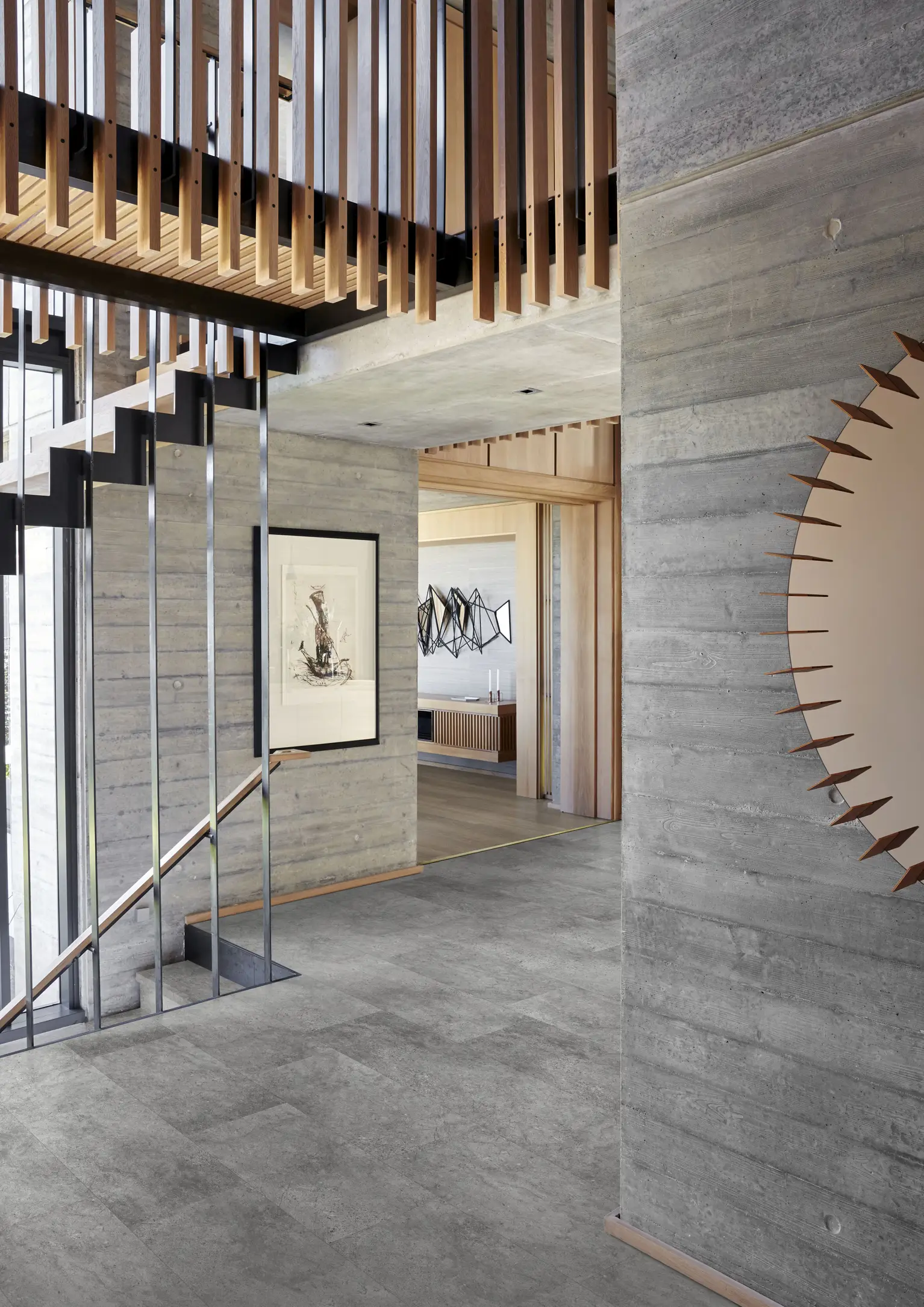 Grossglockner. A modern industrial interior with smooth grey flooring, raw concrete walls, and wooden accents.