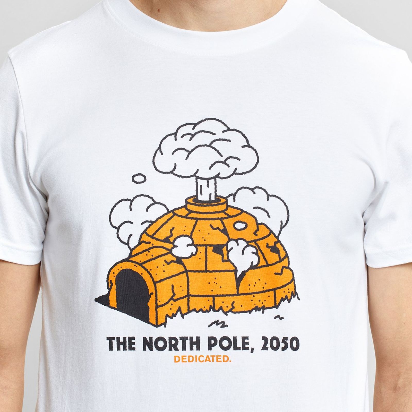 Person wearing a white T-shirt with a cartoon igloo emitting smoke, captioned "The North Pole, 2050. Dedicated."