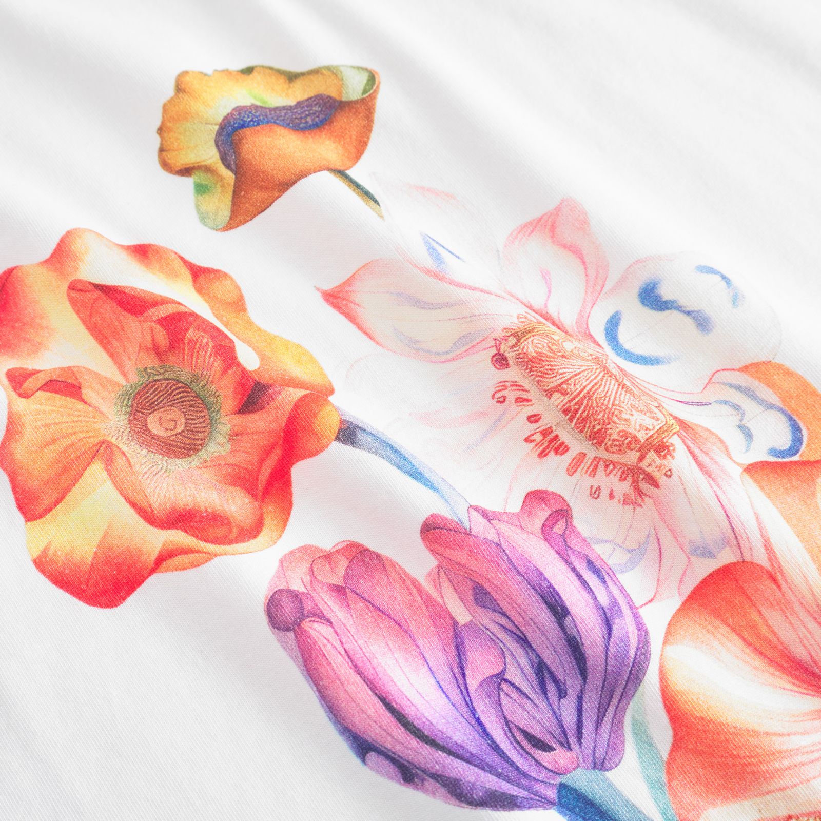 Colorful floral illustration on white fabric, featuring orange, purple, and pink flowers with intricate details and soft shading.