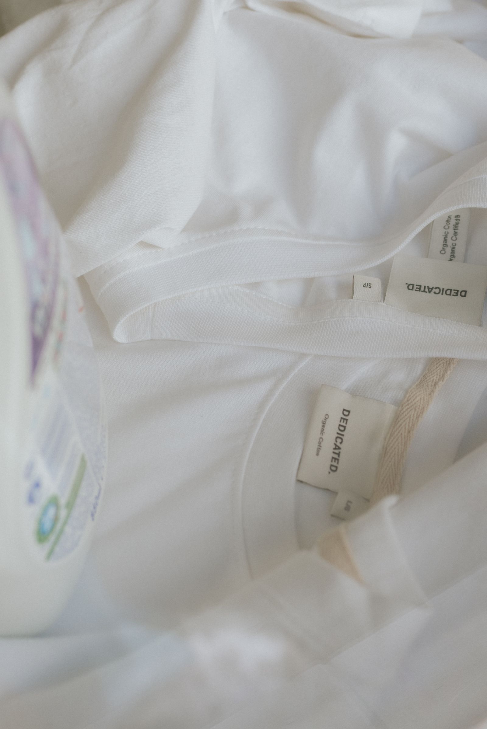 2 white dedicated tshirts with laundry detergent bottle vertical