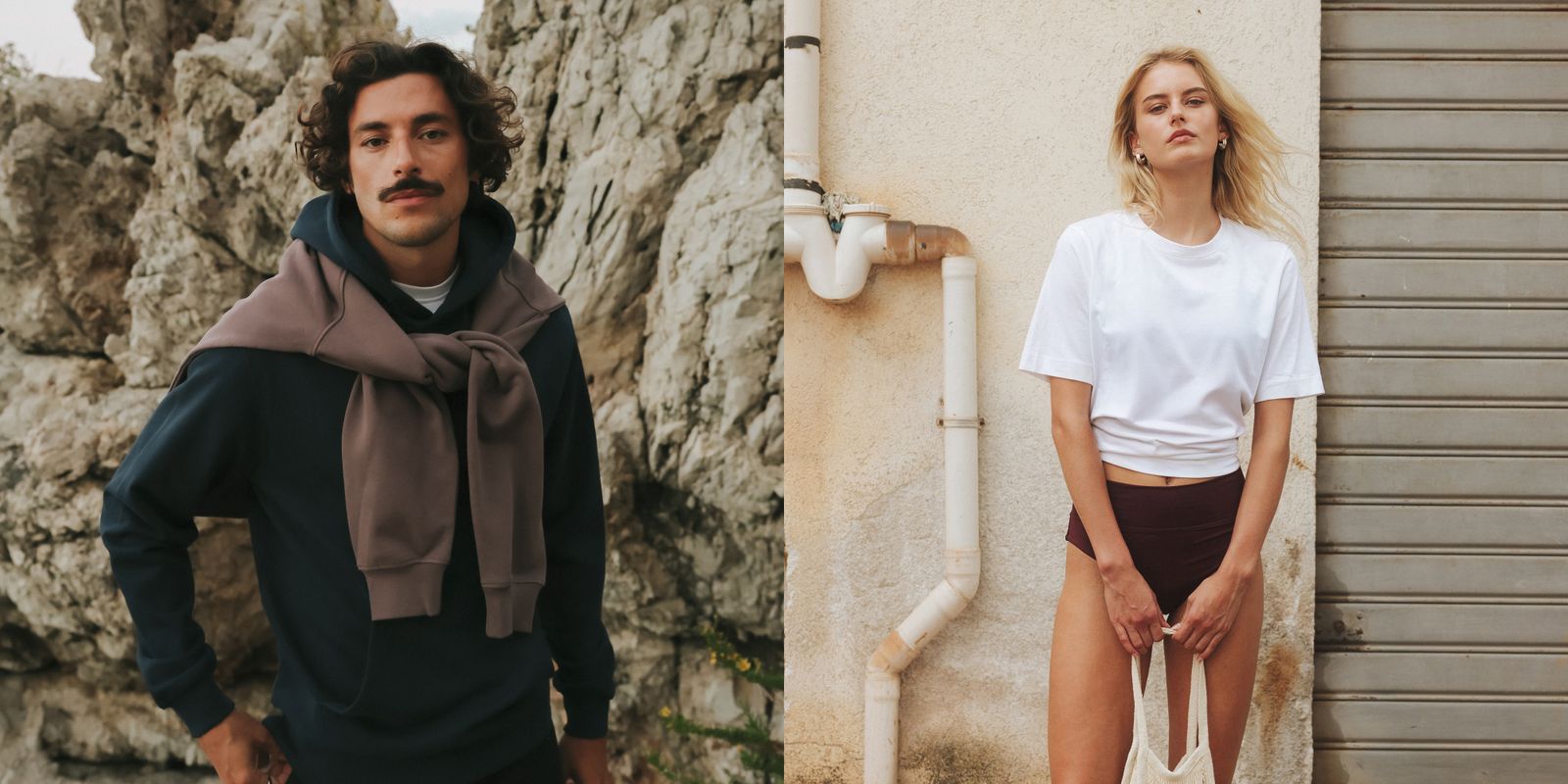 A man with a mustache stands against rocky cliffs, wearing a navy hoodie with a sweater draped over his shoulders; a woman stands by a wall in casual wear.