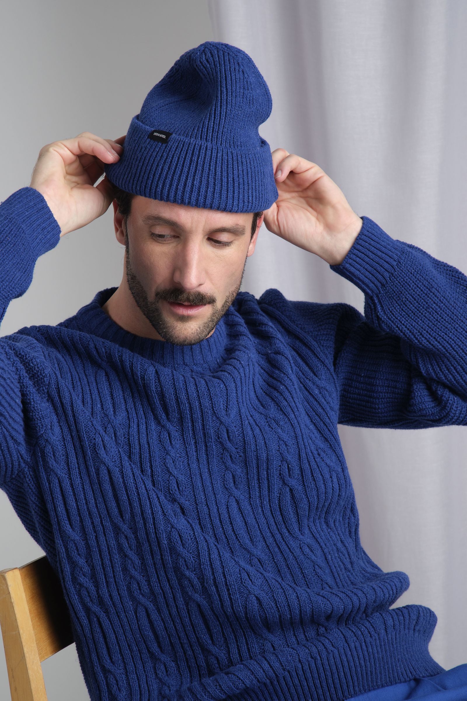 men with matching blue beanie and sweater