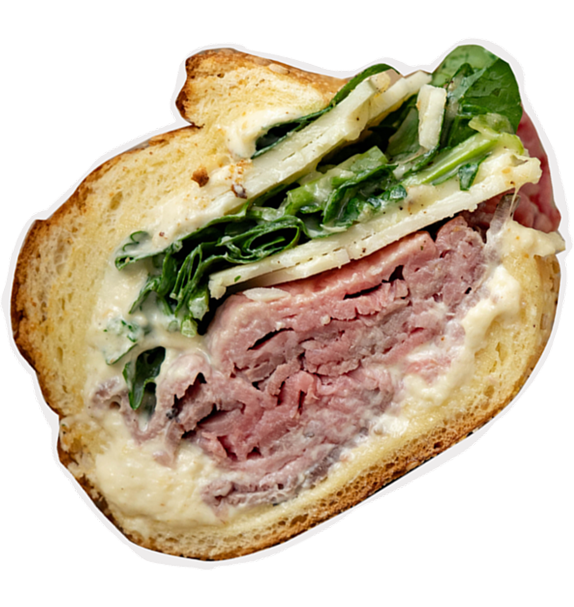 Cross-section of a sandwich with layers of sliced meat, creamy spread, leafy greens, and sliced vegetables between two pieces of bread.