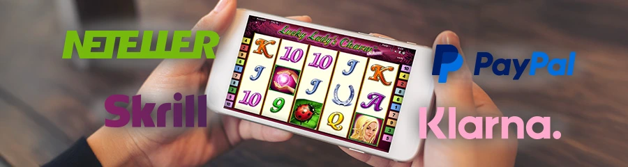 Handy mit Spielautomat und Logos von Klarna, Skrill, PayPal und Neteller