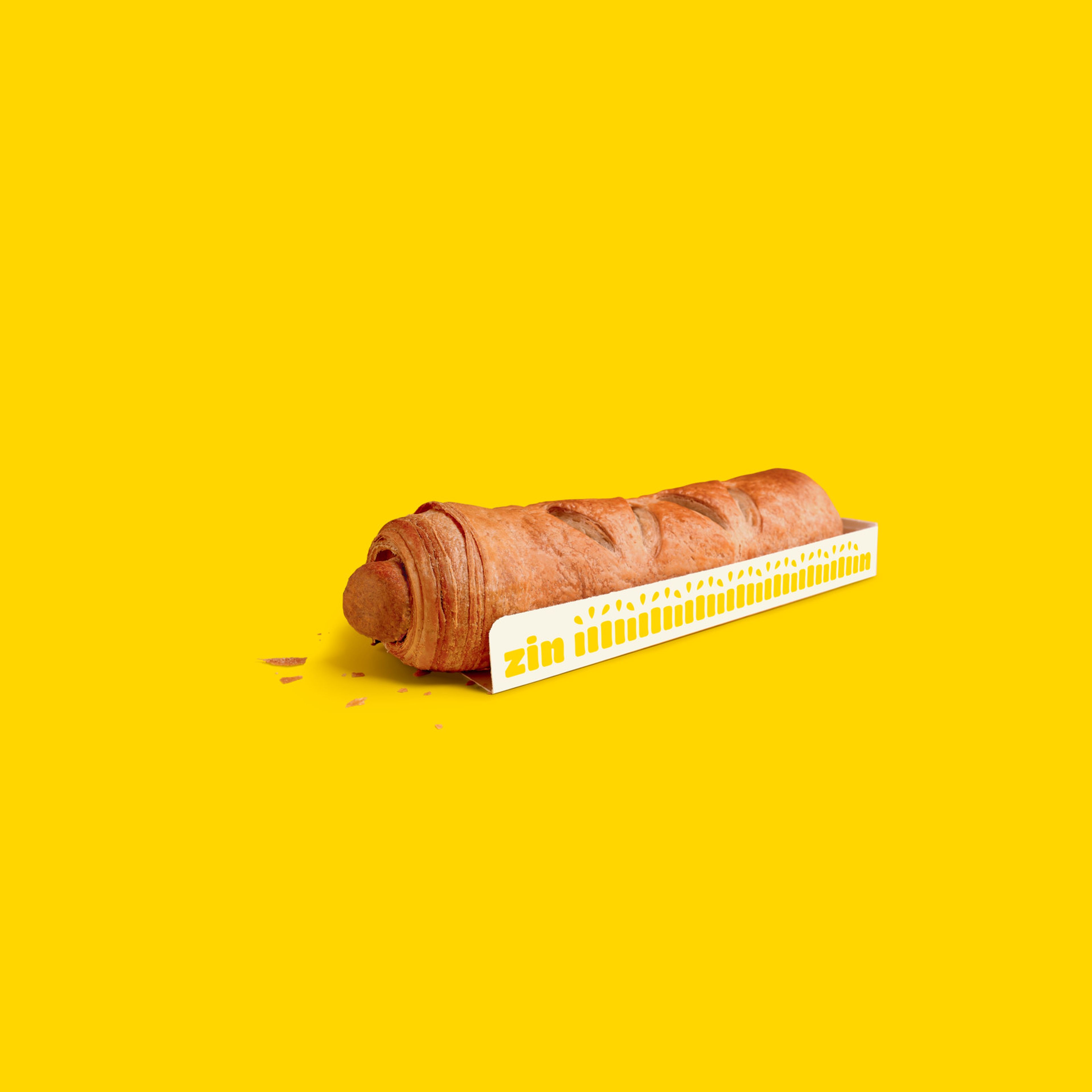 Saucisse végétarienne de Panos sur fond jaune vif, avec une carte portant le texte "envie de".