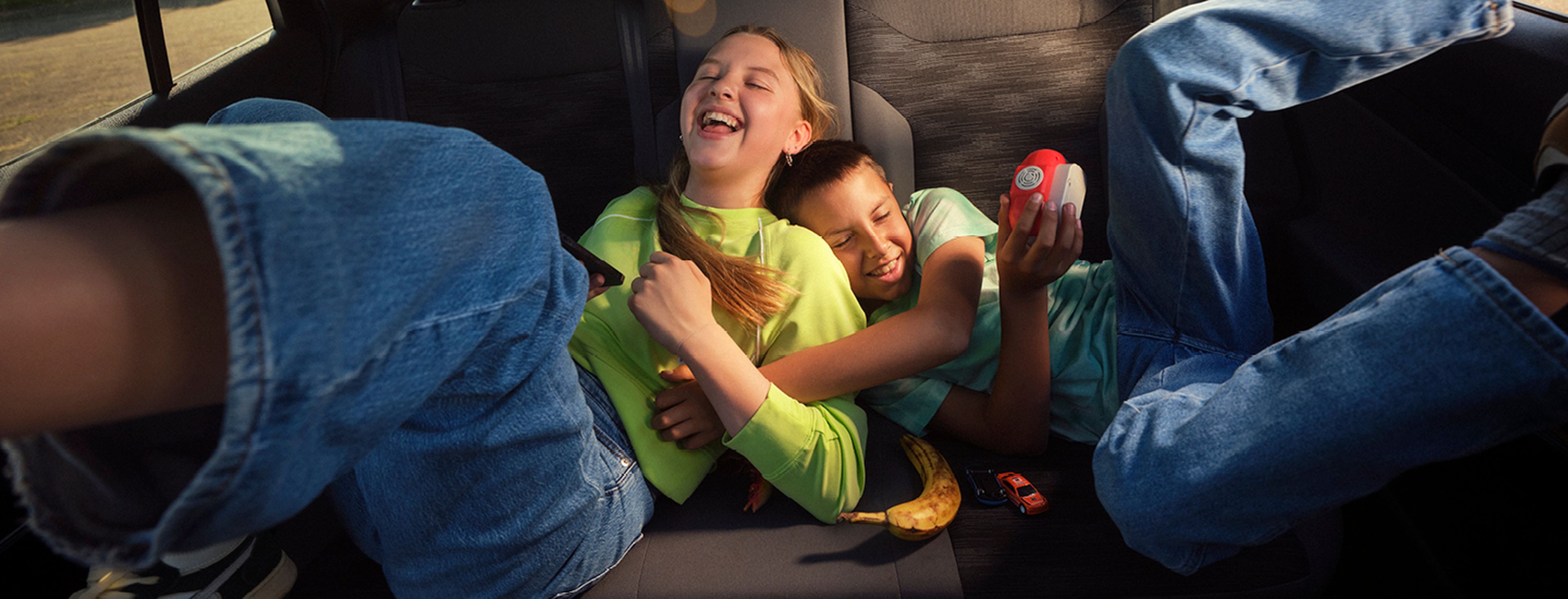 Three friends enjoying a ride in a convertible at Q8