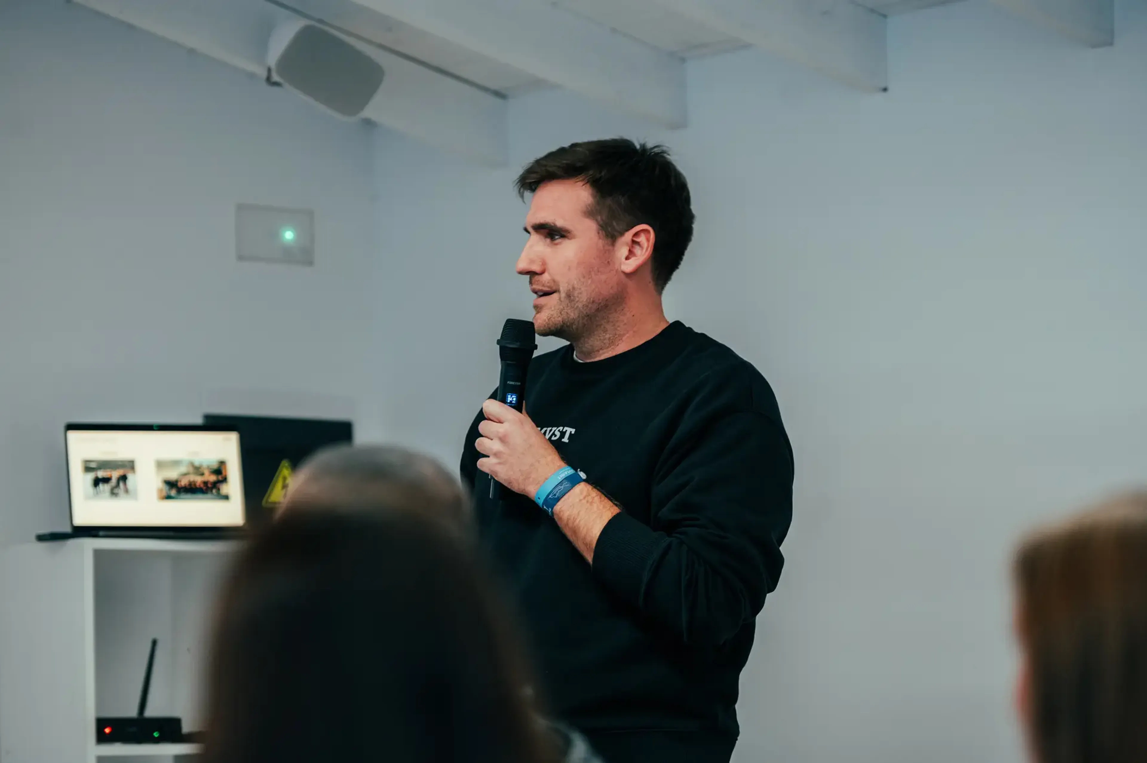 Man holding a mic and talking