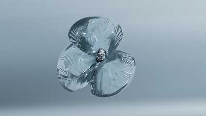 A delicate, transparent glass flower with four petals and a textured center, set against a soft gray background.